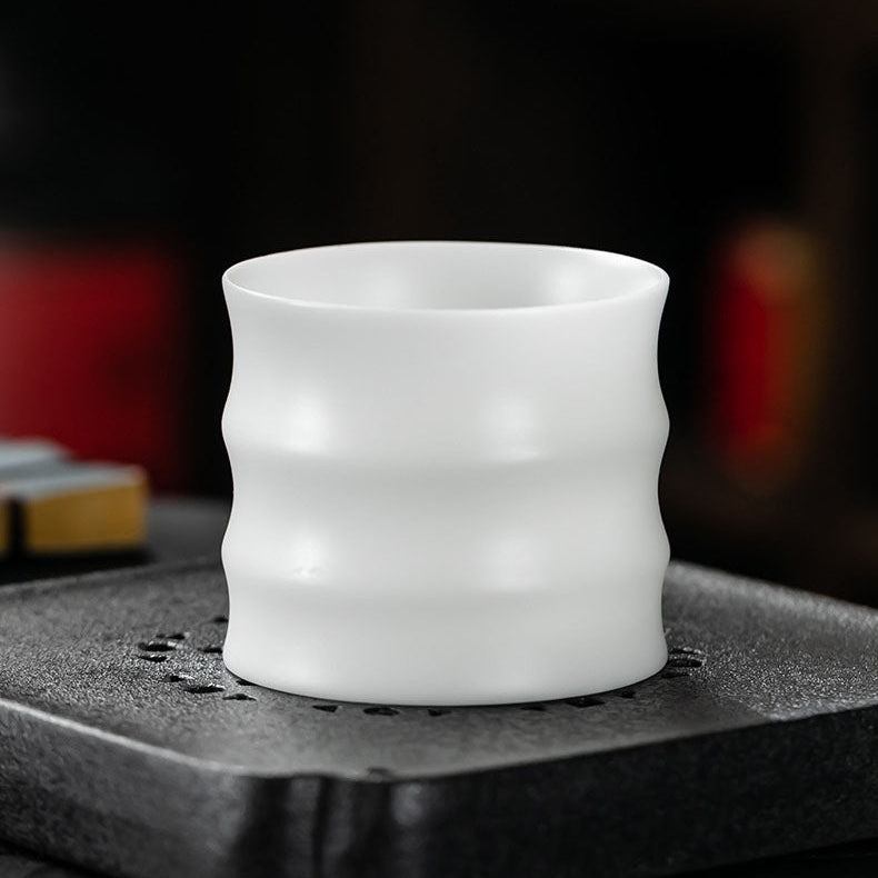 thin walled Dehua jade porcelain tea cup on tea boat